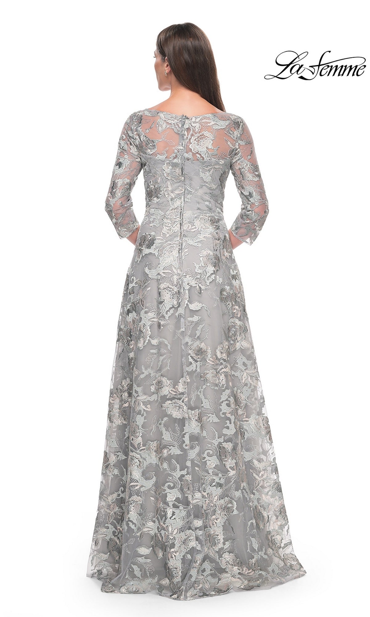 Back view of the Long Formal Dress: La Femme 30062, a floor-length silver gown with three-quarter length sleeves and an overlay featuring floral embroidery.